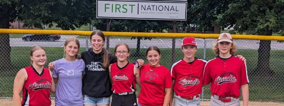 Arcadia youth baseball and softball players pose in fro