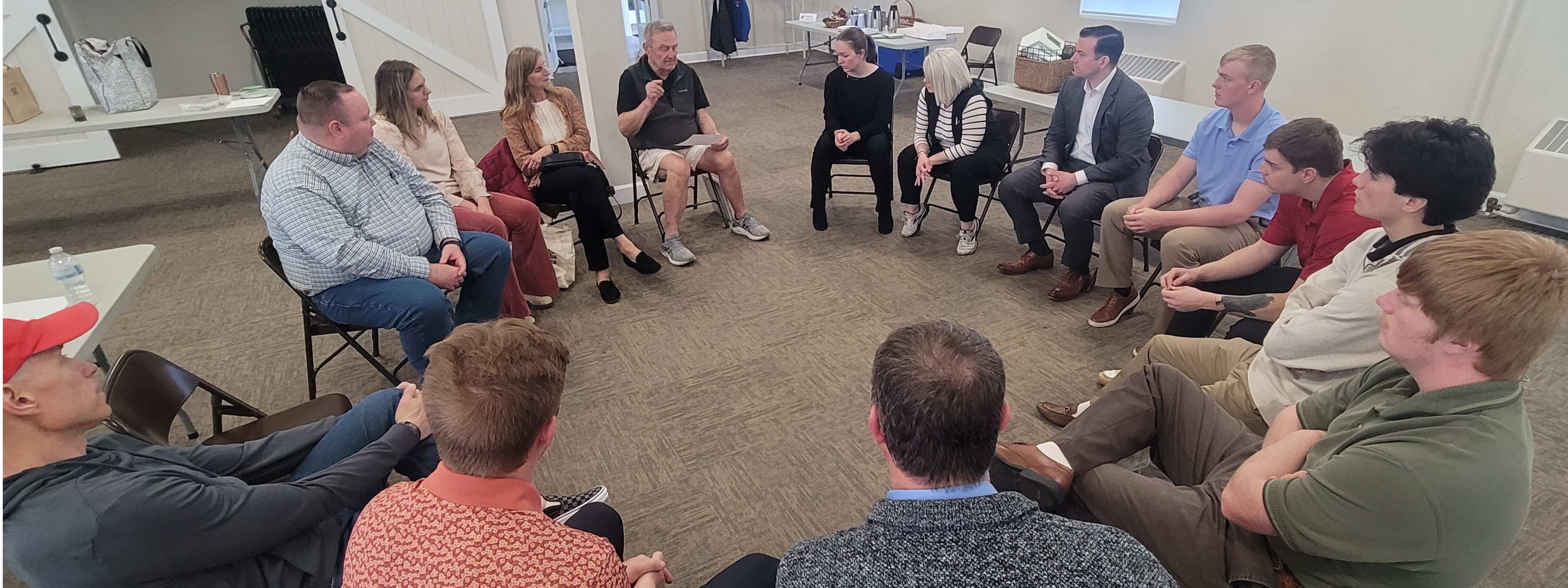 Group of people gather in a circle for discussion