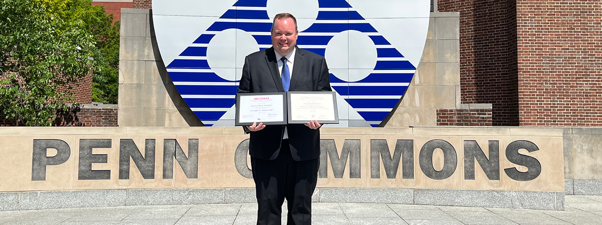 Josh Shofner holding certificates 