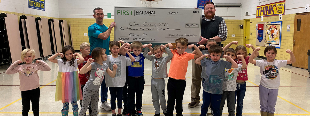 First National Bank employee gifts check to YMCA employ