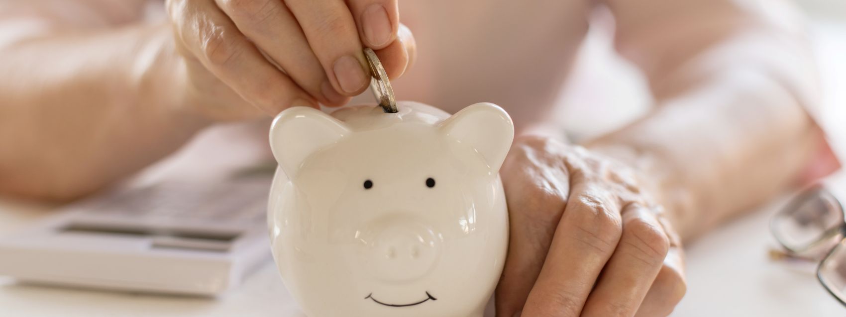 putting coins into a piggy bank