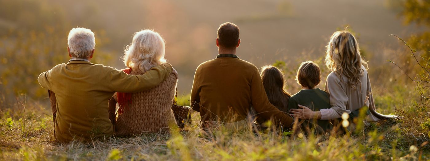 Family sitting in a field