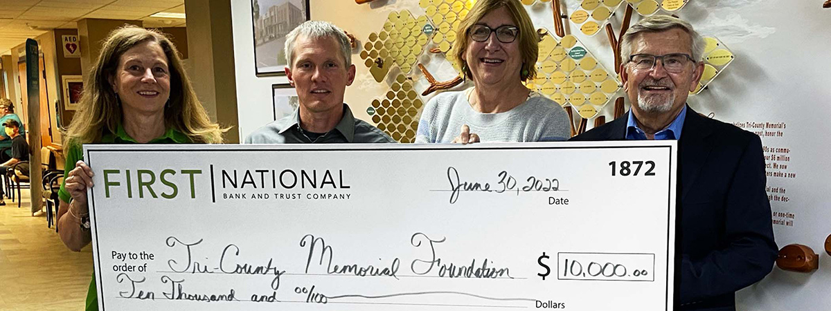 First National Bank donates check to Tri-County Memoria