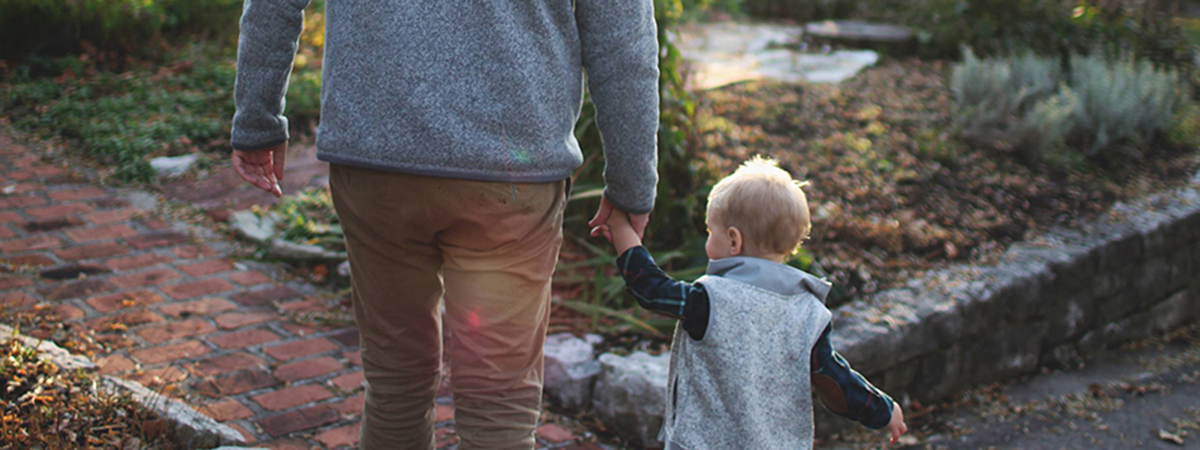 father holding son's hand