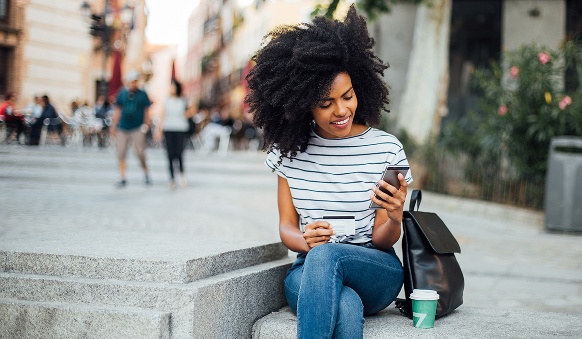 woman sitting looking at her phone